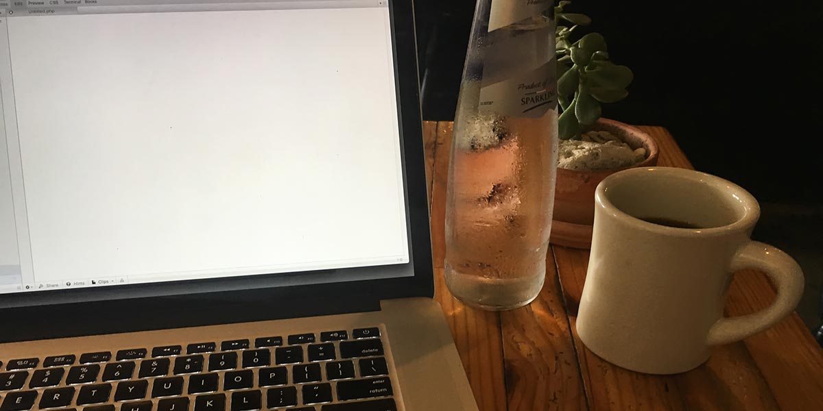 Laptop, coffee, and sparkling water